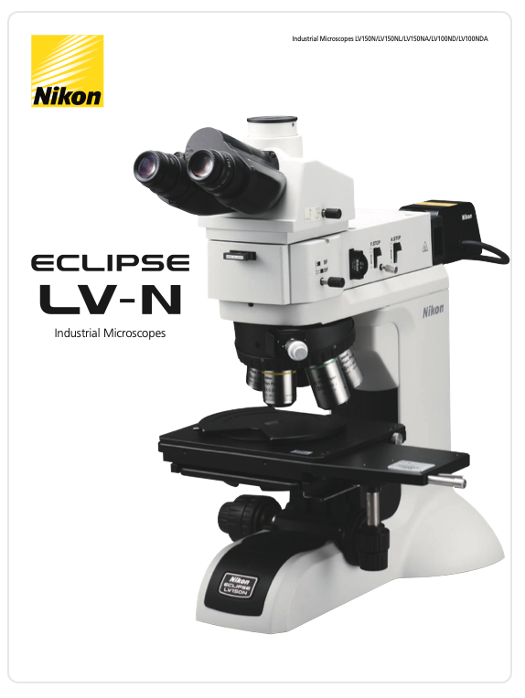 A white and black microscope
Description automatically generated