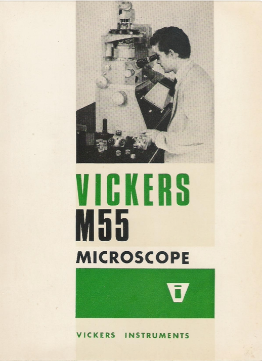 A person looking through a microscope
Description automatically generated