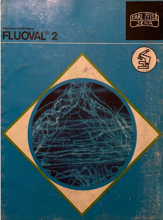 A blue and white cover with a blue circle and a white and green diamond
Description automatically generated
